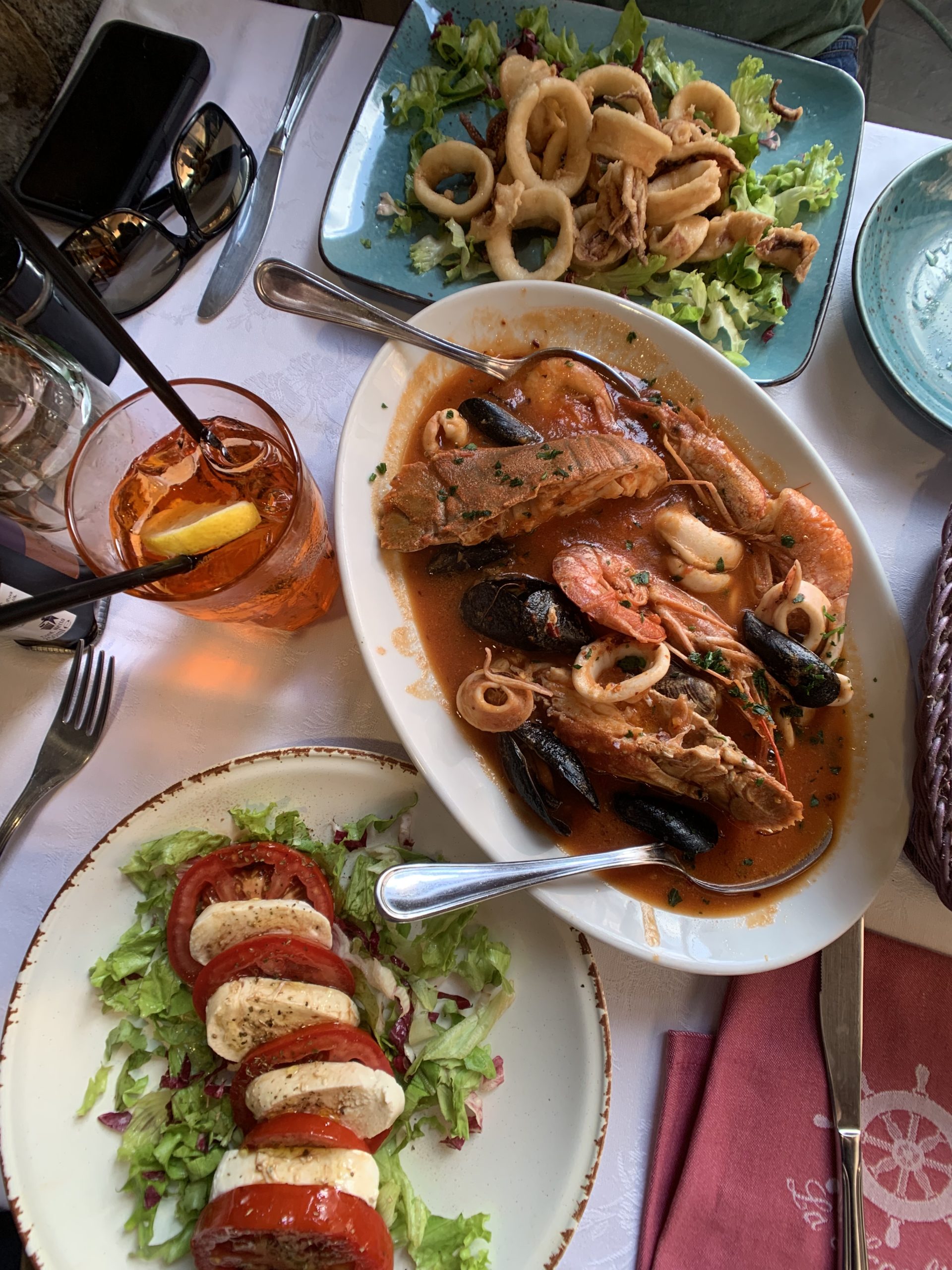 Caprese salad, seafood soup, fired calamari and Aperol Spritz at La Scogliera, Manarola, Cinque Terre, Italy